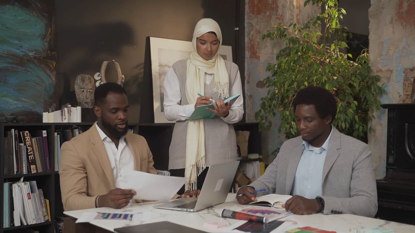 A business team working through plans around a boardroom table